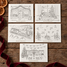 Load image into Gallery viewer, Four square holiday greeting cards arranged on a rustic wooden surface, each with a black line drawing of a seasonal scene and the text 'Season's Greetings' beneath it. The scenes include a storefront, a decorated living room by a window, a train traveling through a landscape, and a snowy village with birds.